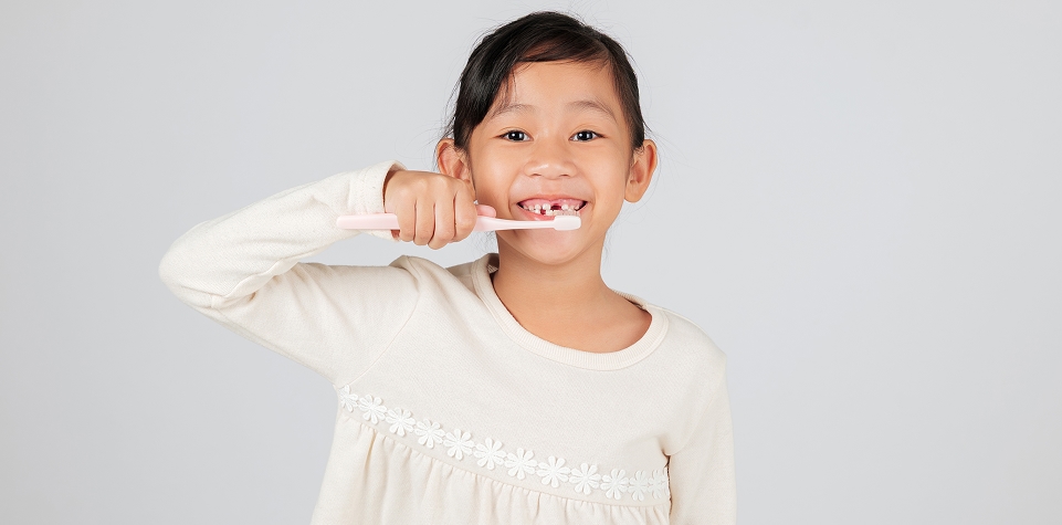 Child brushing their teeth at home