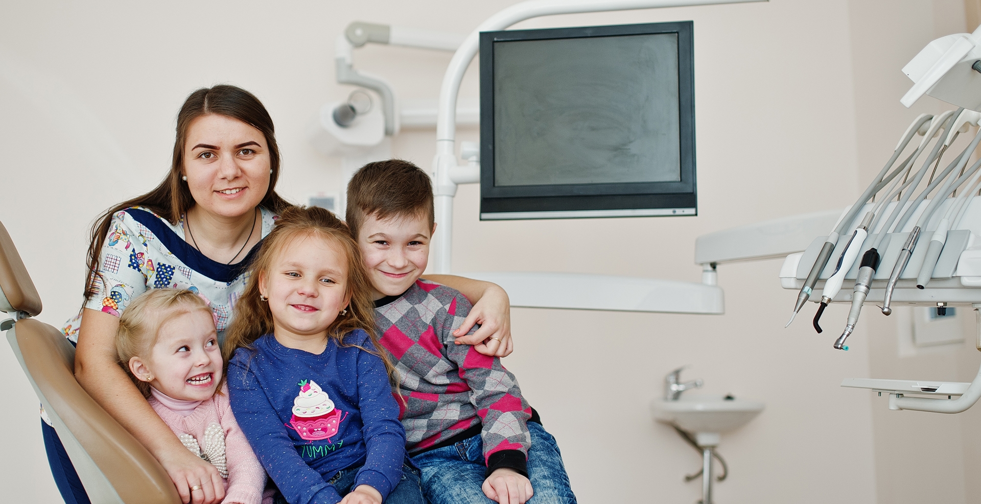 Child learning to brush with guidance from the dental team