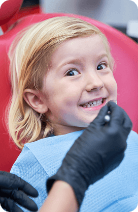 A child smiling during a pediatric dental appointment