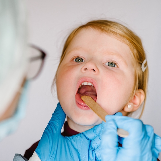 Dentist treating a child during a dental crown visit