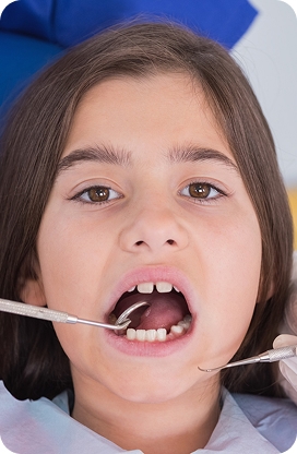 A child smiling during a pediatric dental appointment