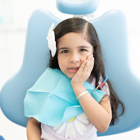 Dentist teaching a child about dental care