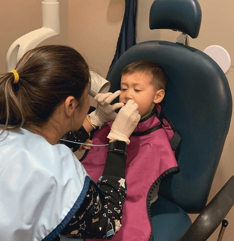 Our team using modern dental technology with a young patient