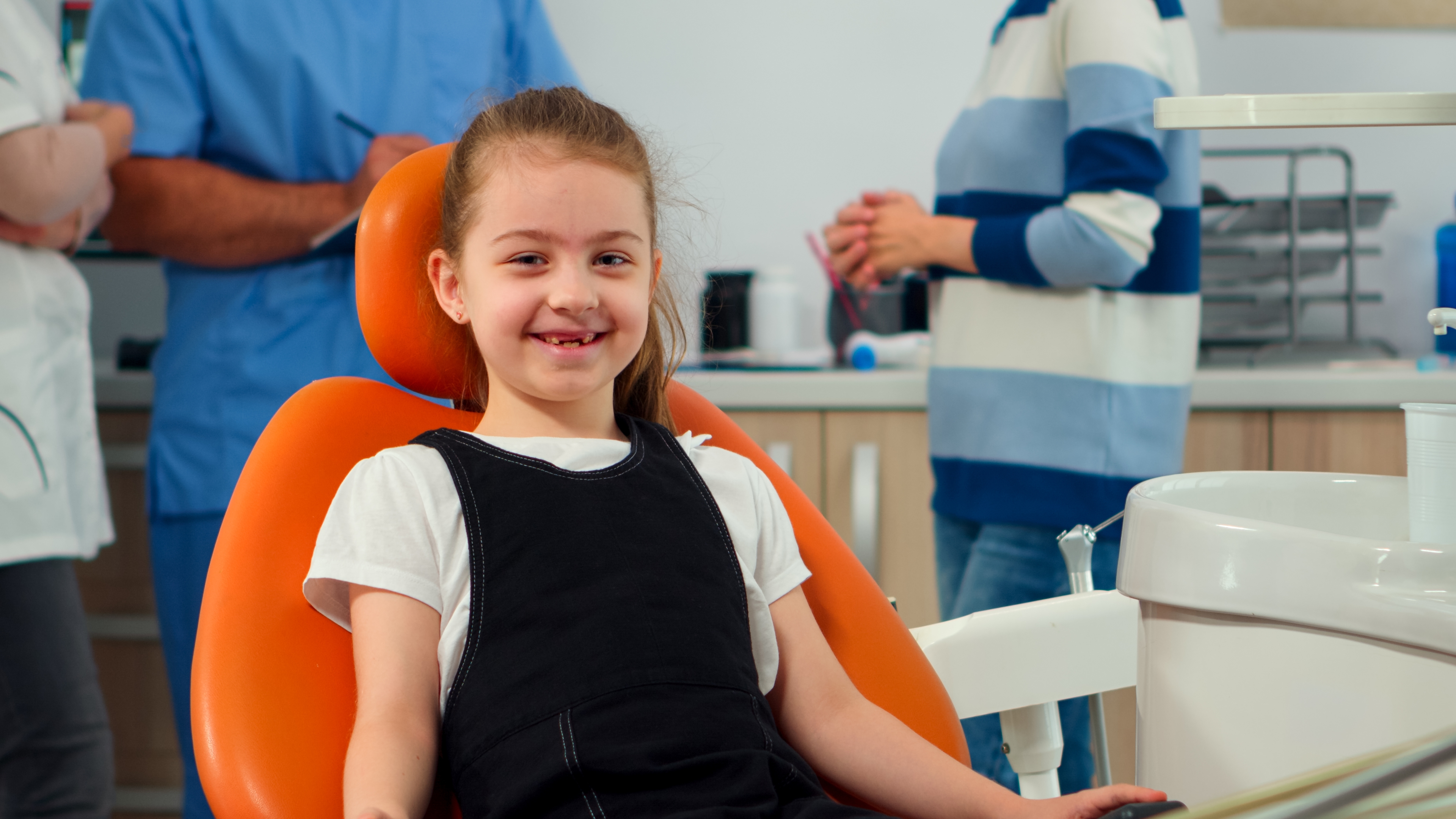 A young patient smiling in the dental chair