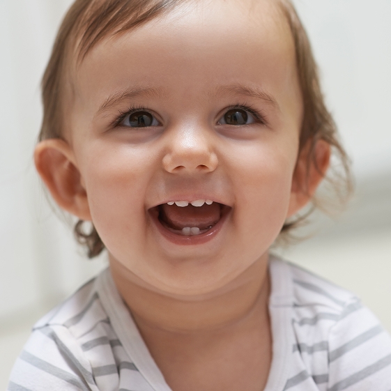 Pediatric dentist with a baby and parent