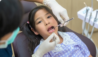 Child showing a restored tooth
