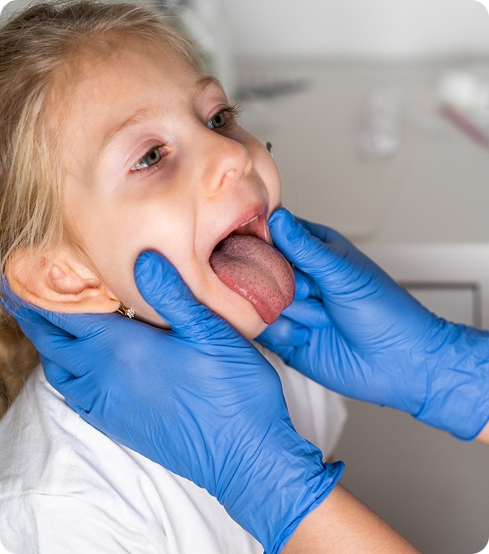Board-certified pediatric dentist examining a young patient