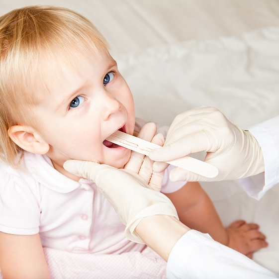 Pediatric dentist evaluating an infant