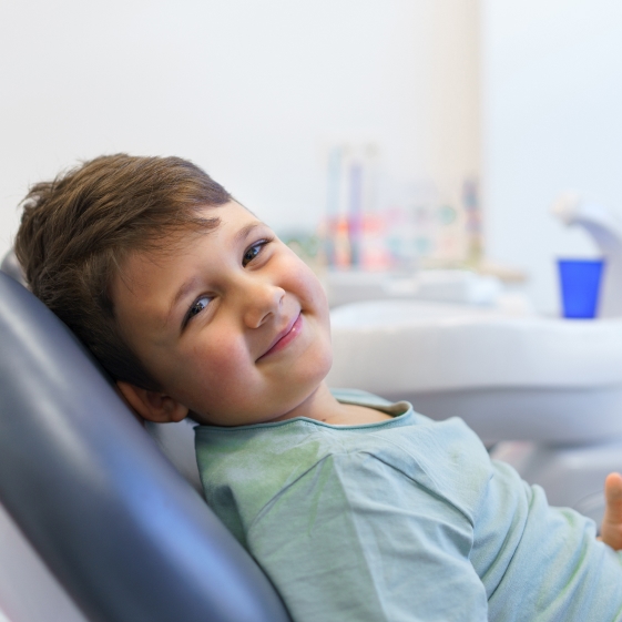 Dentist treating a child during a dental crown visit