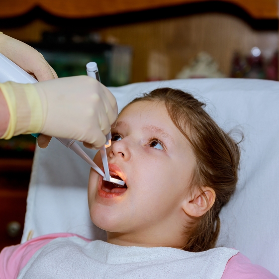 Dentist teaching a child about dental care