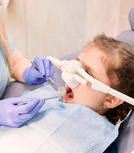 Young child smiling and showing healthy teeth