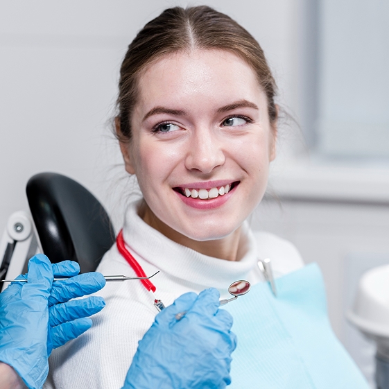 Teen talking with a pediatric dentist